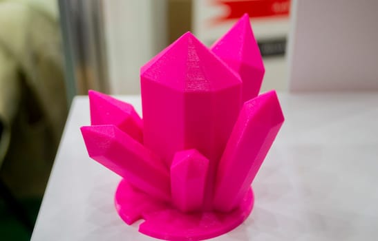 Abstract art object printed on 3D printer. Colored pink creative model printed 3D printer from molten ABS PLA plastic filament. Object printed FDM printer. Additive progressive new modern technology