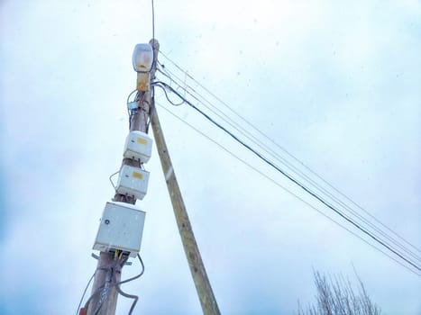 Old pole with wires against the sky. Electric transmission line, Eco-friendly energy