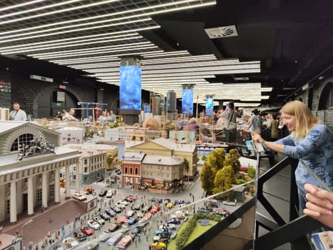 Saint-Petersburg, Russia - August 03, 2023: grand project Russia. Layout of city, country, street, landscape with small toy people, houses, roads, cars, nature and visitors tourists in the museum