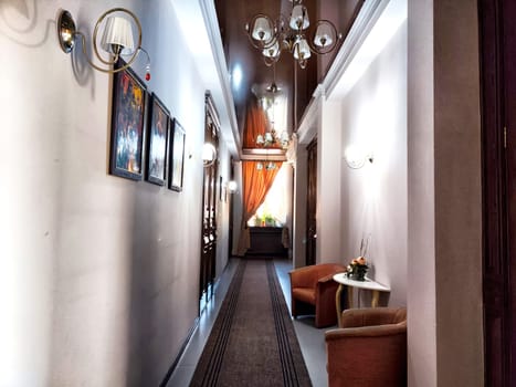 Elabuga, Russia - February 25, 2024: Hallway adorned with paintings and traditional decor in a warm, dim light