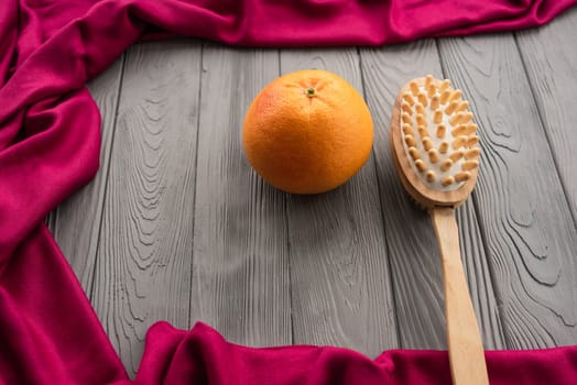 skin preparation body beach anti-cellulite massage cactus brush big orange peel. Summer background template mockup free space pattern composition sample text. Top view above grey wooden background