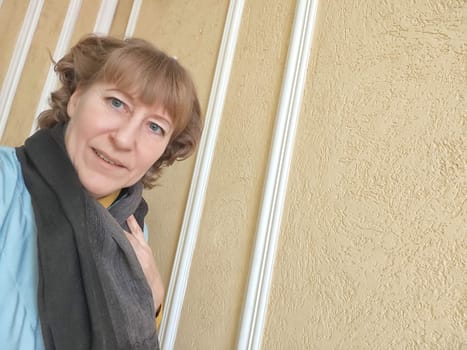 Portrait of cute blonde girl indoors. Funny middle-aged woman posing and taking selfie indoors