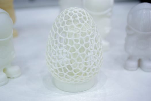 Abstract art object printed on 3D printer. White creative model printed on 3D printer from molten ABS, PLA plastic filament. Object printed on FDM printer. Additive progressive new modern technology
