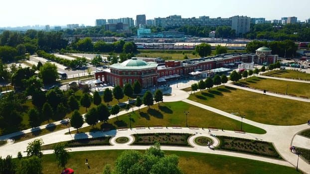 Top view of historic building with garden patterns on sunny day. Creative. Landscape design of garden with patterns near historic building. Historical complex with garden on background of modern city.