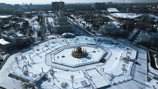 Top view of round square in winter. Creative. Beautiful historical square with fountain on sunny winter day. Sovetskaya Square with architecture and square in city center.