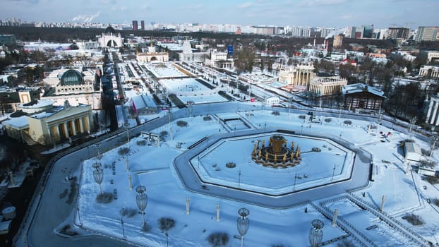 Historic square with fountain in winter. Creative. Top view of beautiful square with fountain on sunny winter day. Historical square of Soviet city with beautiful architecture in winter.