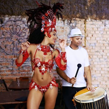 Women, samba dancer and carnival with smile, stage and band with fashion, culture or creativity in nightclub. Girl, people and dancing with music, drums or tradition for celebration in Rio de Janeiro.