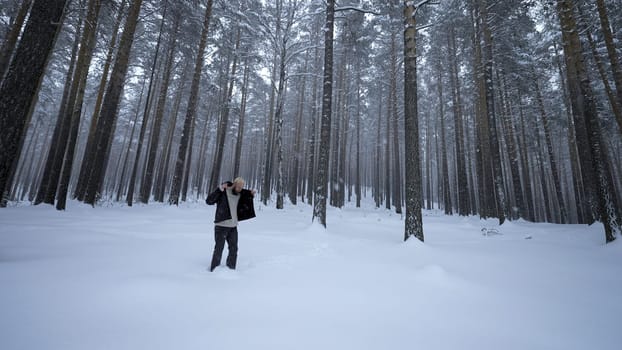 Man dancing in winter forest. Media. Stylish man moves like in clip in winter forest. Shooting clip of rapper dancing in winter forest.