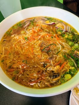 Fresh and vibrant Asian noodle soup, served hot in Fort Wayne, Indiana - an invitation to relish authentic comfort food.