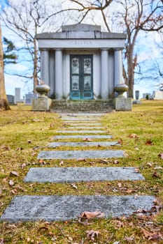 Pathway to the Past: Serene view of the Griffin Mausoleum at Lindenwood Cemetery, Fort Wayne, Indiana, capturing themes of heritage, peace, and time's passage.