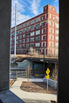 Urban Exploration in Fort Wayne - Discovering Hidden History through a Glimpse of Red Brick Industrial Architecture Amidst Daytime Cityscape