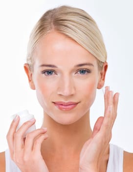 Woman, portrait and moisturiser product for skincare healthy or dermatology wellness, cream or white background. Female person, face and hand with lotion in studio for self care, sunscreen or mockup.