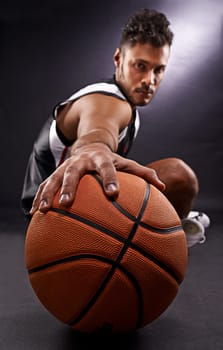Man, portrait and basketball playing for sports game in studio or professional exercise, athlete or black background. Male person, training and fitness pride or workout competition, uniform or mockup.
