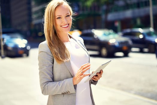 Smile, tablet and portrait of businesswoman, urban or city for corporate employee. Confidence, technology or commute or travel to workplace in New York, business consultant of female entrepreneur.