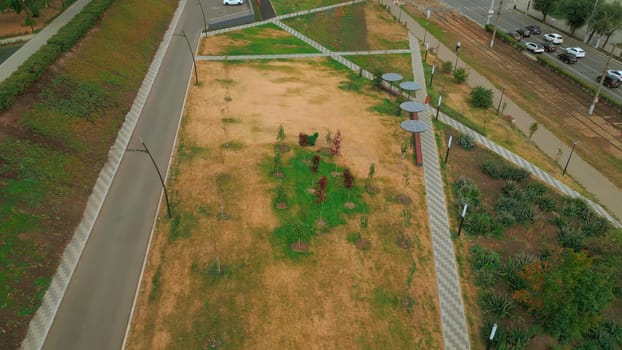 Top view of paths in park alley. Clip. Solar panels in park alley of city. Lines of paths in park city alley of residential area.