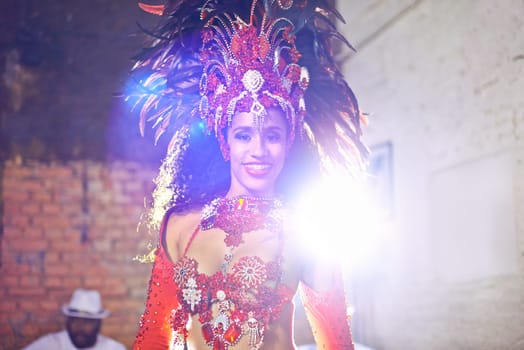 Woman, samba and performance with portrait, smile and makeup for concert or party. Brazilian dancer, celebration and feather for culture, talent and creative artist for rio de janeiro carnival event.