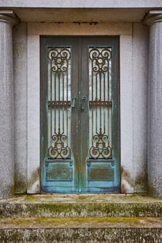 Weathered bronze mausoleum doors with intricate ironwork, silently telling a story of time and memory at Lindenwood Cemetery, Indiana.