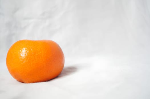A small orange on a white background. High quality photo