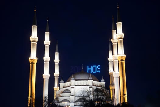 A large white mosque with blue letters. High quality photo