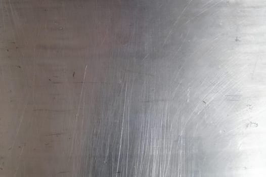 A silver surface with a lot of scratches and marks. High quality photo