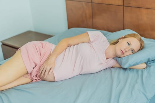 Sleep-deprived pregnant woman struggles with insomnia, navigating the challenges of restlessness during pregnancy.