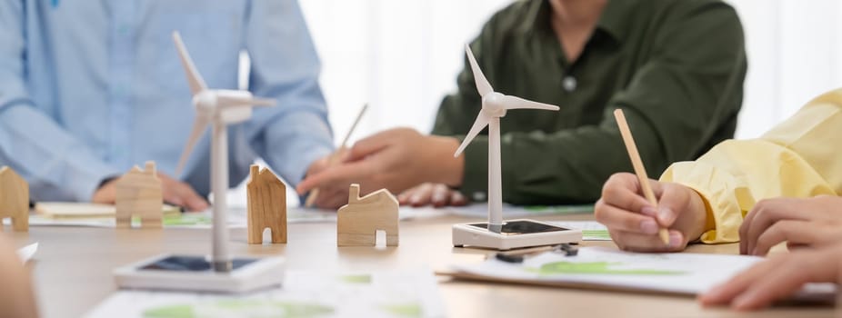 Green business meeting represented renewable energy. Skilled businesspeople discuss green business investment at table with environmental documents. Closeup. Focus on hand. Delineation.