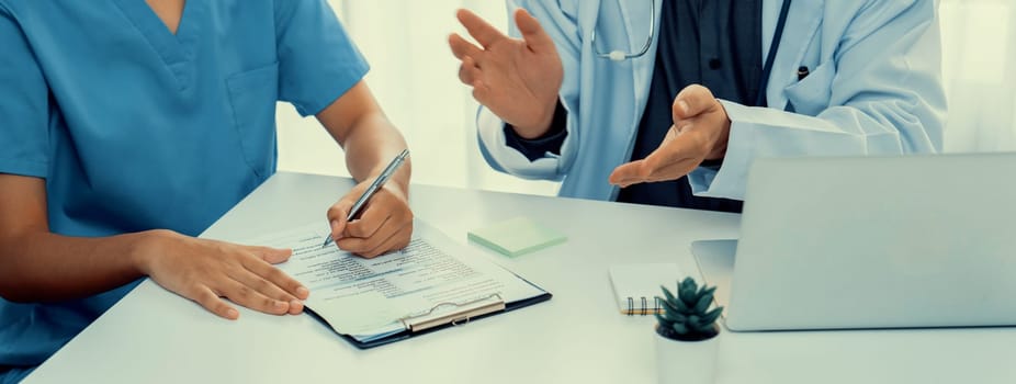 Professional various team of medical working and planning medical treatment at hospital table together. Teamwork lead to successful illness and sickness treatment. Panorama Rigid