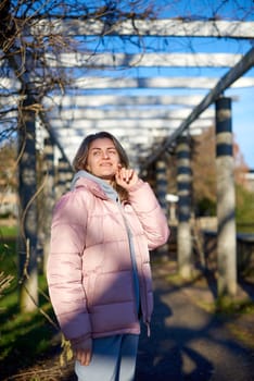 Winter Fun in Bitigheim-Bissingen: Beautiful Girl in Pink Jacket Amidst Half-Timbered Charm. Step into the festive winter spirit with this captivating image of a lovely girl in a pink winter jacket standing in the archway of the historic town of Bitigheim-Bissingen, Baden-Württemberg, Germany. The backdrop features charming half-timbered houses, enhanced by warm vintage photo processing, creating a delightful scene of winter joy and architectural beauty.