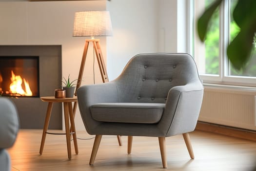 A cozy living room with a comfortable chair, elegant lamp, and a warm fireplace. The wooden furniture and flooring enhance the interior design