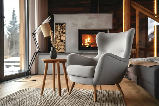 A cozy living room with a wooden chair, rectangular table, and fireplace fixture. The interior design includes hardwood flooring, large window, and comfortable seating