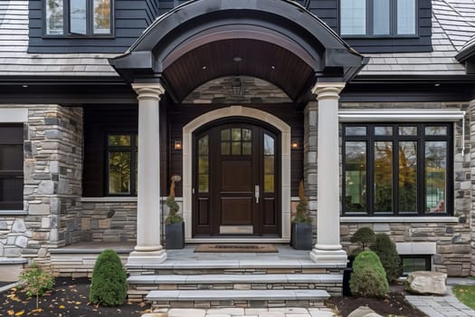 A grand building with a spacious porch, a large front door, and stunning brickwork. Surrounding the house is lush grass and elegant windows