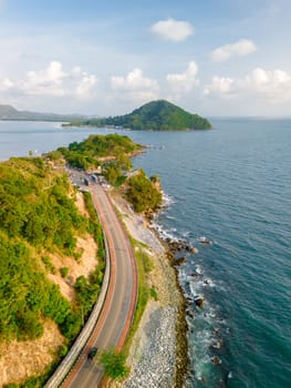 car driving on the curved road of Thailand. road landscape in summer. it's nice to drive on the beachside highway. Chantaburi Province Thailand, vertical photo