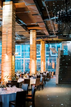 Set festive tables in a restaurant with large windows. High quality photo
