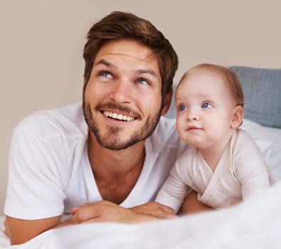 Happy, cute and baby with father on bed relaxing, playing and bonding together at home. Smile, love and young dad laying with girl child, infant or kid in bedroom or nursery at family house