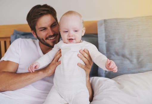 Family, love and father with baby in bedroom for bonding, relationship and care for parenting. Happy, home and dad playing with newborn infant for child development, support and affection in house.