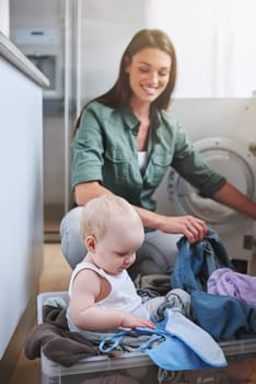 Laundry, washing and mother with baby in home for multitasking, housekeeping and housework. Family, parenting and mom with newborn in clothing basket for cleaning, hygiene and maintenance on floor.