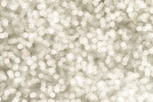 Silver Sparkling Lights Festive background with texture. Abstract Christmas twinkled bright bokeh defocused and Falling stars. Winter Card or invitation