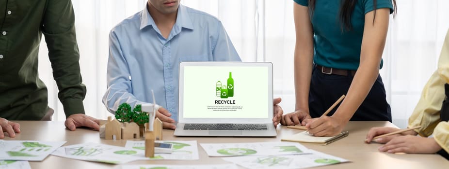 Recycle packaging displayed on laptop at a green business meeting while business team presenting green design. ESG environment social governance and Eco conservative concept. Closeup. Delineation.