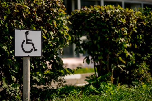 Road sign on a background of asphalt. Disabled parking. The texture of the tarmac, top view.