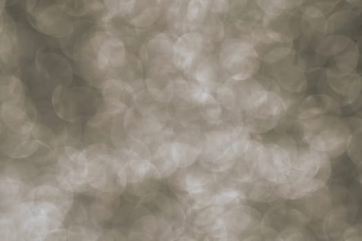 Silver Sparkling Lights Festive background with texture. Abstract Christmas twinkled bright bokeh defocused and Falling stars. Winter Card or invitation