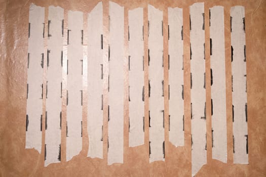 Strips of uses of masking tape along the edges of the paint.