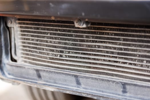 beaten but alive car air conditioner radiator with rock hit traces