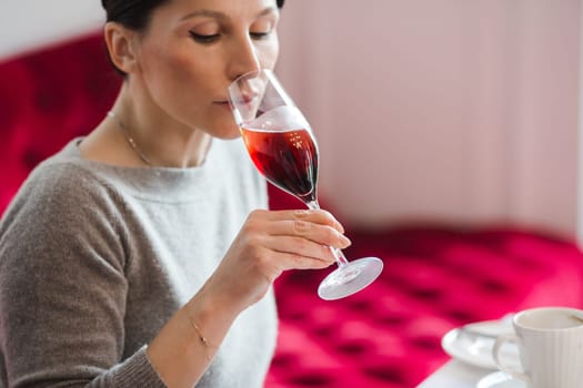 Elegant woman looking away while drinking cocktail in restaurant.