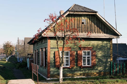 Charming wooden house with vintage window, rustic architecture, and countryside allure. Nostalgic symbol of simpler life, surrounded by natures beauty. Perfect for rustic charm and serene landscapes.