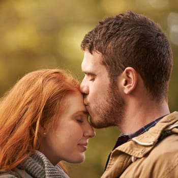 Couple, forehead kiss and outdoor for love, romance and passion for romantic, dating and relationship together. Boyfriend, girlfriend and young people with eyes closed for happy and care in park.