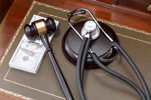 An image depicting a judge's gavel, a medical stethoscope, and a stack of US currency, highlighting the costly nature of legal and medical services