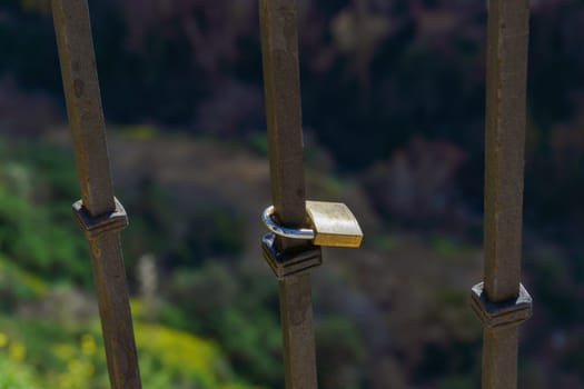 close-up of a padlock on a metal fence