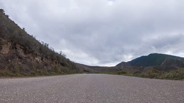 In this serene winter scene, a vehicle carefully makes its way along Los Osos Valley Road and Pecho Valley Road within Montana de Oro State Park.