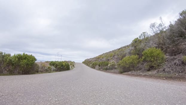 In this serene winter scene, a vehicle carefully makes its way along Los Osos Valley Road and Pecho Valley Road within Montana de Oro State Park.