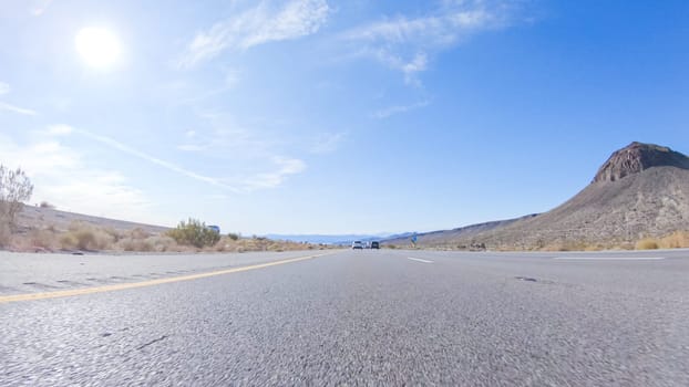 Embarking on a road trip from Nevada to California, driving on Highway 15 during the day offers scenic views and an exciting journey between states.